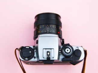 Black and Silver Camera on Brown Wooden Table